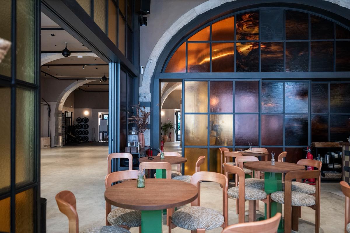 The caf&eacute; tables, with the studio floor through the open doors behind
