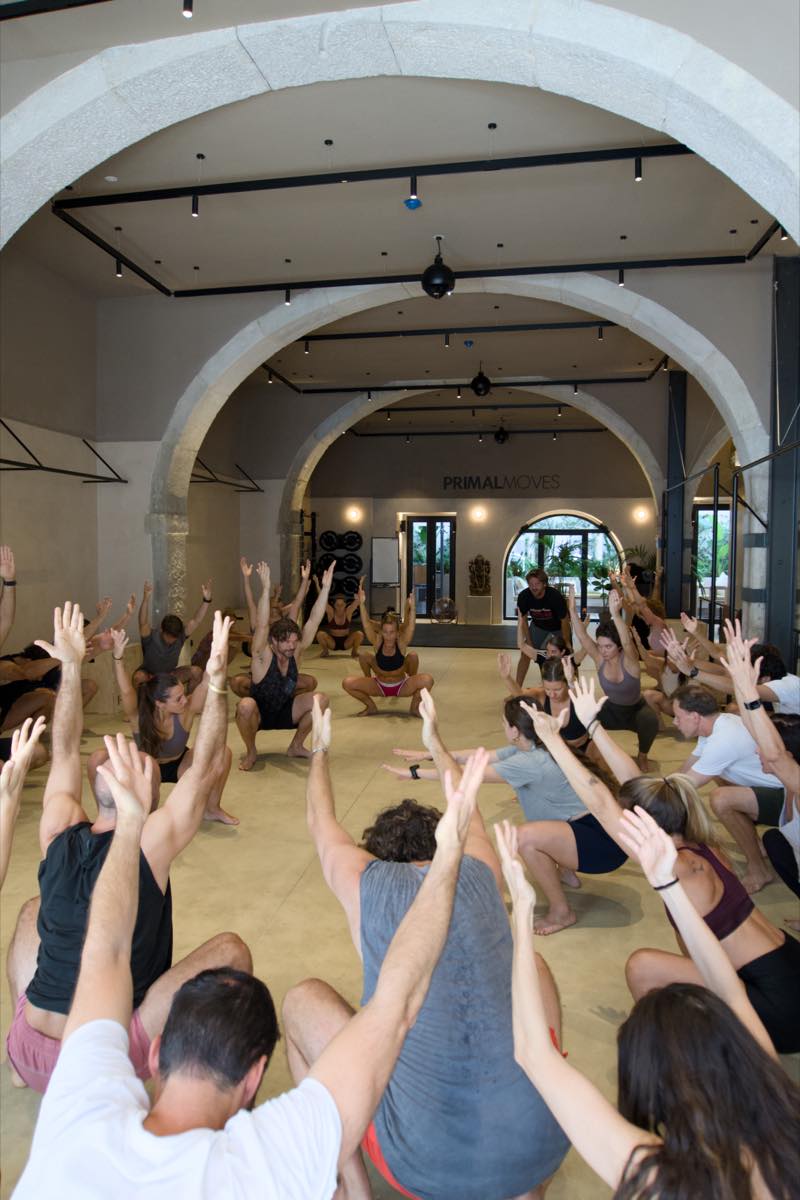 A full class with arms raised