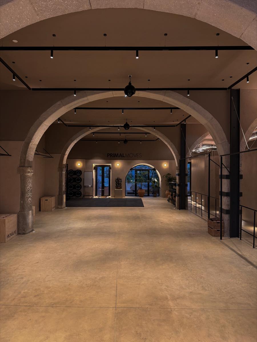 The studio floor, empty, under its stone arches
